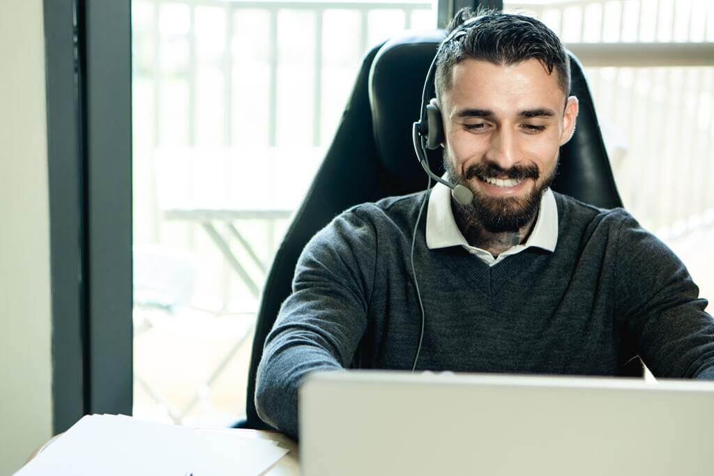 male call center agent is smiling